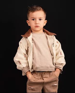 Young boy wearing a neutral casual outfit